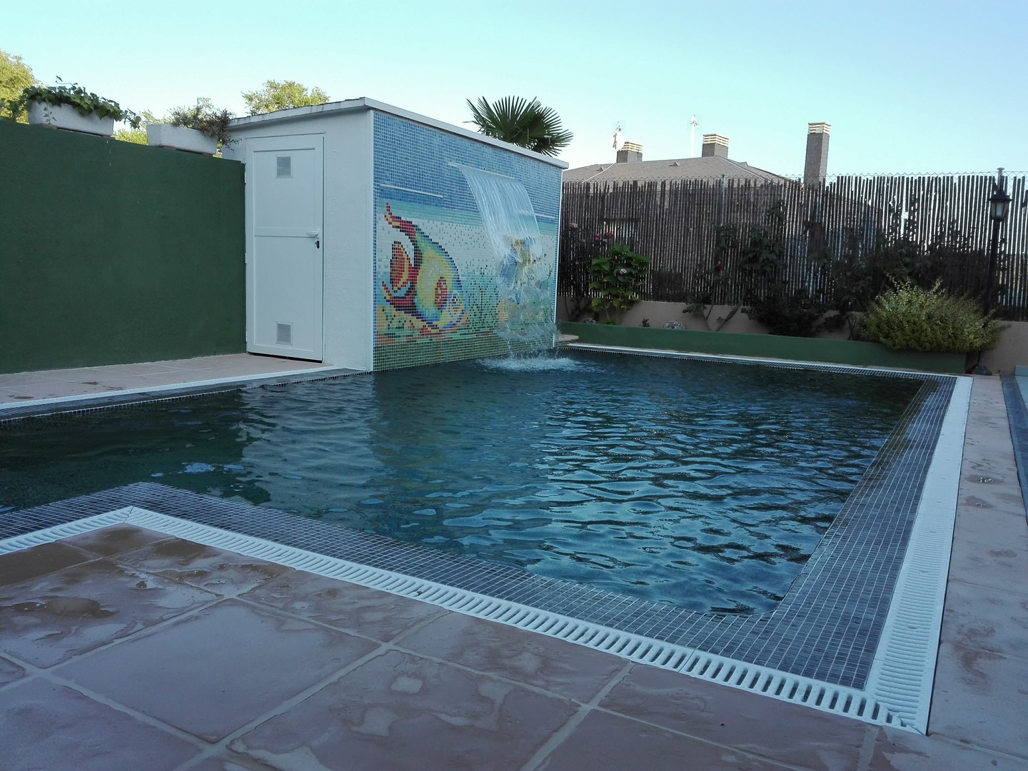 Stylish residential swimming pool illuminated with LED lighting at night.