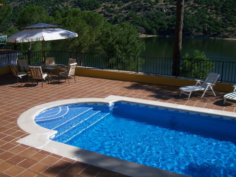 Custom outdoor swimming pool with waterfall feature and contemporary finish.
